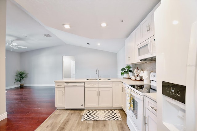 kitchen featuring sink, light hardwood / wood-style flooring, kitchen peninsula, white appliances, and white cabinets