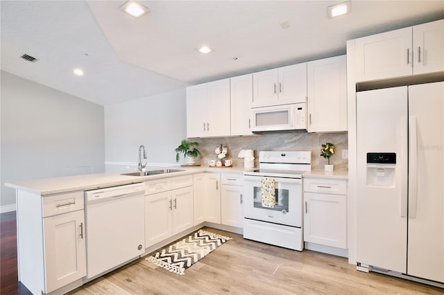 kitchen featuring white cabinetry, white appliances, and sink