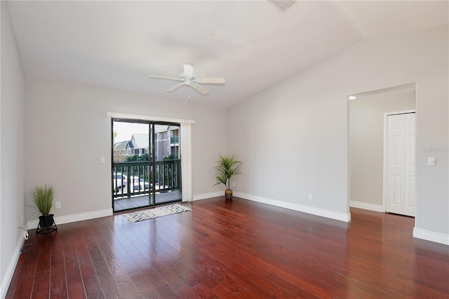 spare room featuring lofted ceiling, ceiling fan, and dark wood-type flooring