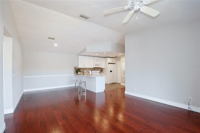 unfurnished living room with dark hardwood / wood-style floors, ceiling fan, a textured ceiling, and vaulted ceiling