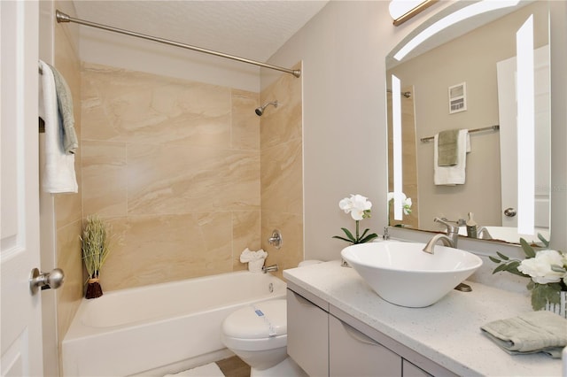 full bathroom with vanity, toilet, and tiled shower / bath