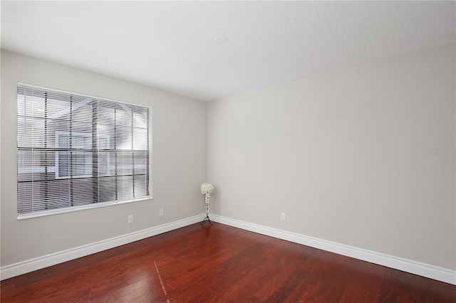 unfurnished room with dark hardwood / wood-style floors