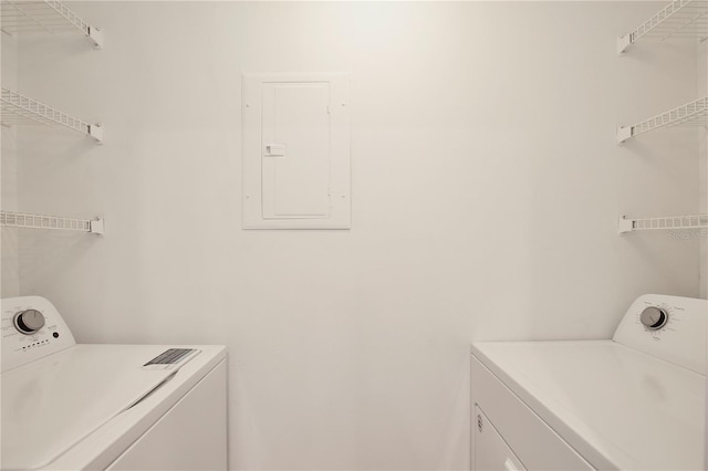 washroom with independent washer and dryer and electric panel