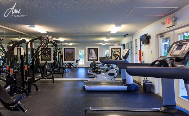 exercise room with crown molding and a textured ceiling