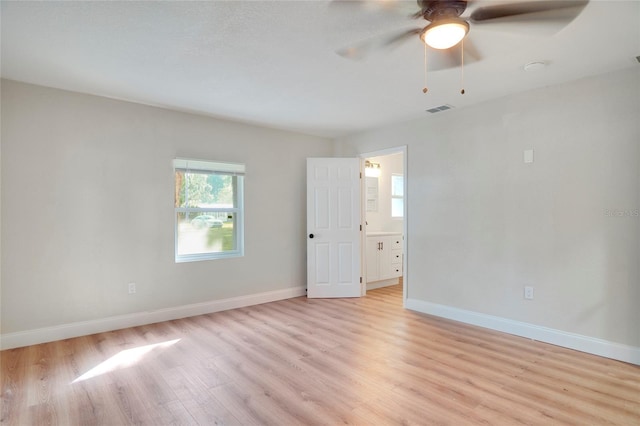 empty room featuring light wood-type flooring and ceiling fan