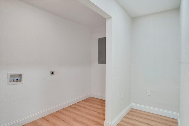 spare room with electric panel and wood-type flooring