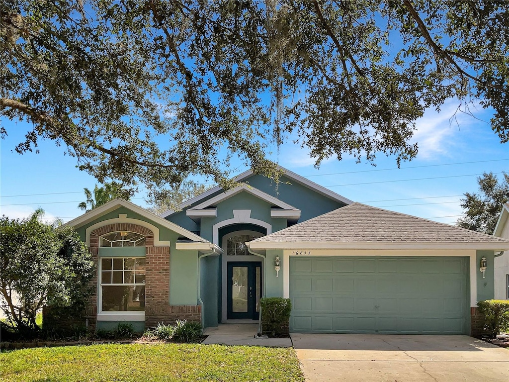 view of front facade with a front yard and a garage