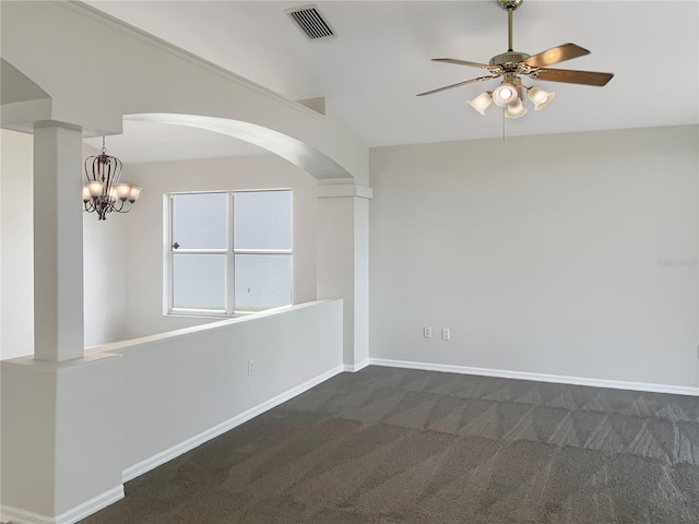 carpeted empty room featuring lofted ceiling and ceiling fan with notable chandelier