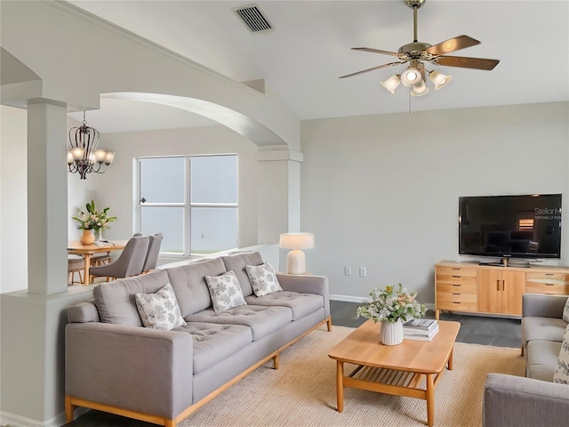 living room featuring hardwood / wood-style flooring, ceiling fan with notable chandelier, and vaulted ceiling