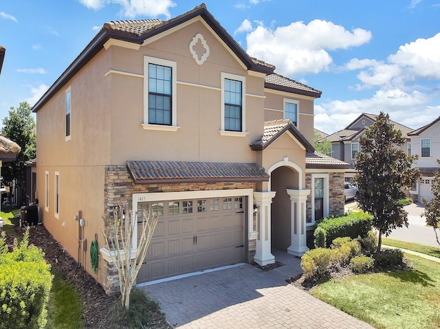 mediterranean / spanish-style home featuring a garage and cooling unit