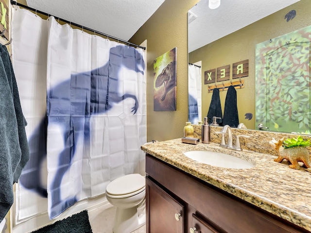 bathroom featuring a shower with shower curtain, vanity, toilet, tile patterned flooring, and a textured ceiling