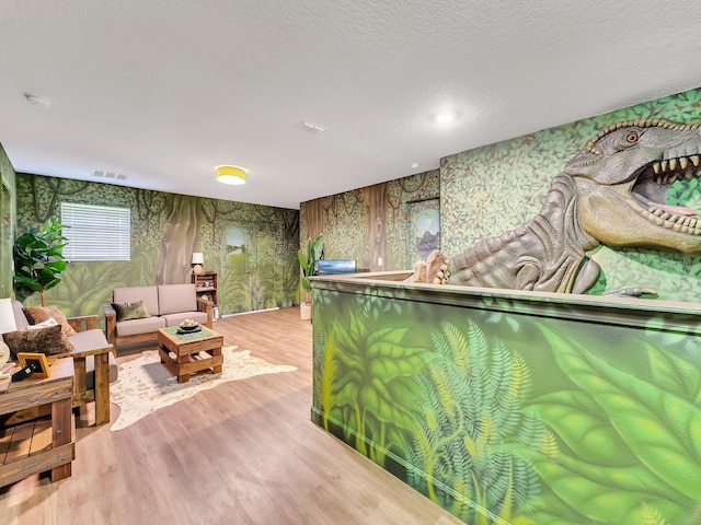 interior space featuring light hardwood / wood-style floors and a textured ceiling