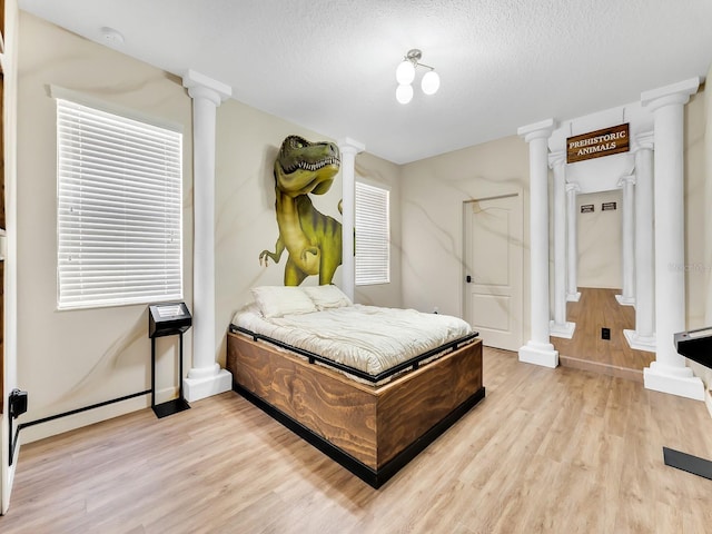 bedroom featuring a textured ceiling and light wood-type flooring