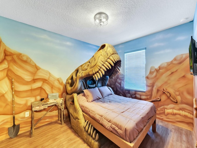 bedroom with wood-type flooring and a textured ceiling