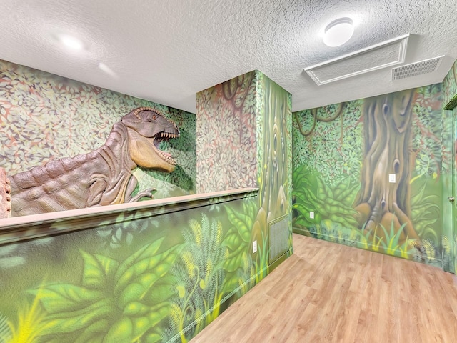 miscellaneous room with hardwood / wood-style floors and a textured ceiling