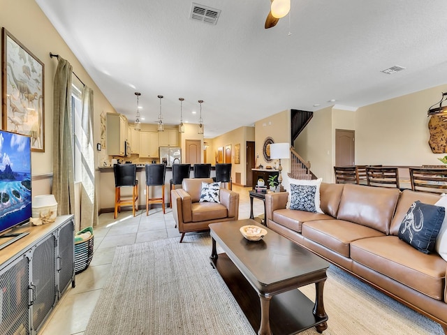 living room with ceiling fan and light tile patterned floors