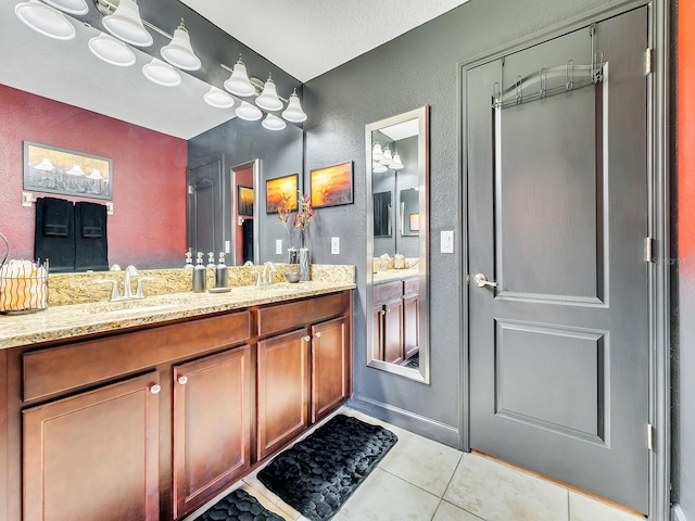 bathroom with vanity, tile patterned flooring, and a textured ceiling