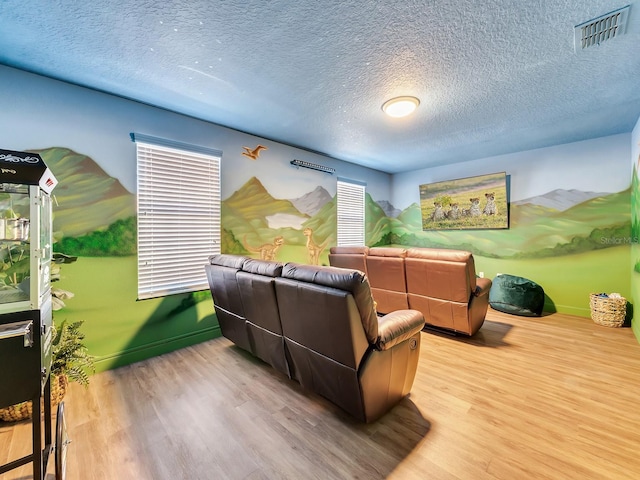 interior space featuring hardwood / wood-style floors, a healthy amount of sunlight, and a textured ceiling