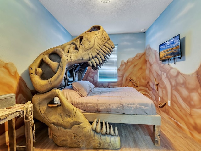 bedroom featuring hardwood / wood-style floors and a textured ceiling