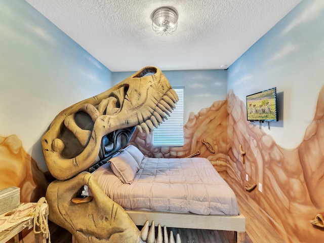 interior space with a textured ceiling and hardwood / wood-style flooring