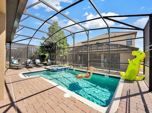 view of pool featuring glass enclosure, an in ground hot tub, and a patio