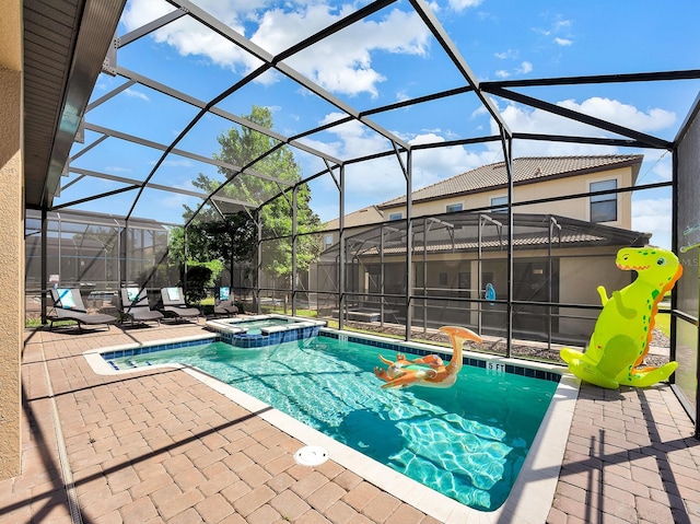 view of pool with glass enclosure, an in ground hot tub, and a patio