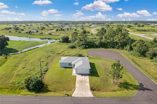 birds eye view of property featuring a water view and a rural view