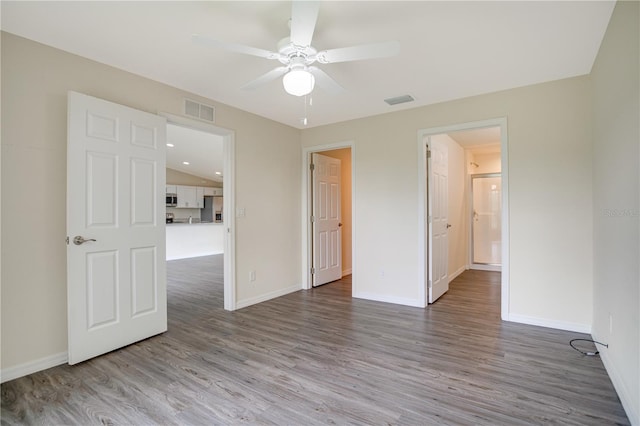 empty room featuring hardwood / wood-style floors and ceiling fan