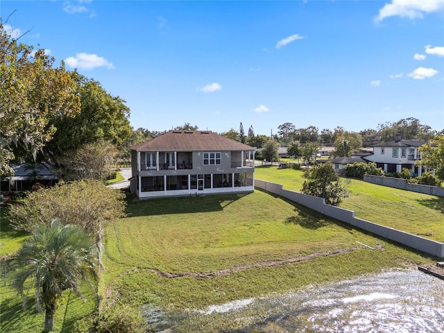 view of front of property featuring a sunroom and a front yard