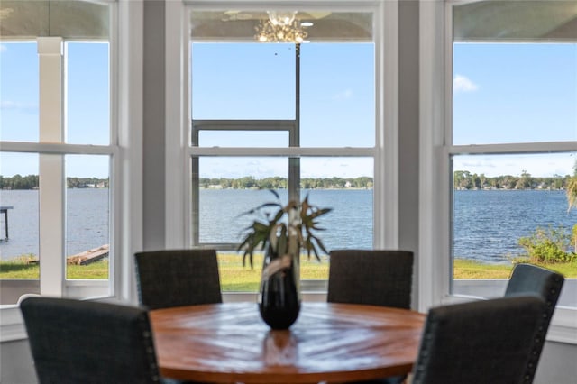 dining room with an inviting chandelier and a water view