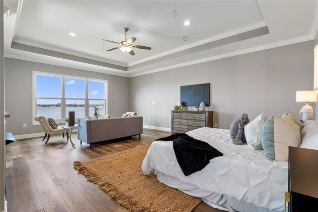 6019 Linneal Beach Dr, Apopka, FL 32703 - bedroom with crown molding, baseboards, a tray ceiling, and hardwood / wood-style flooring