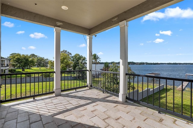 view of patio / terrace with a balcony and a water view