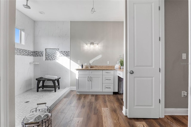 bathroom featuring vanity, wood-type flooring, and walk in shower