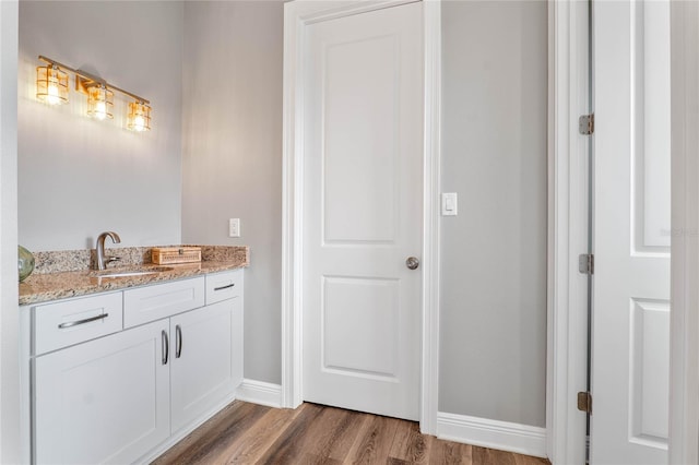 bathroom with vanity and hardwood / wood-style floors