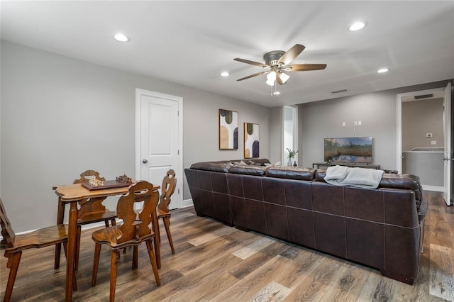 living room featuring hardwood / wood-style floors and ceiling fan