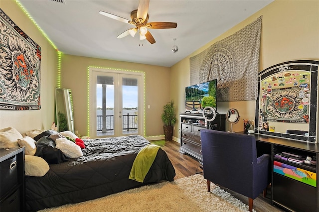 bedroom featuring access to outside, ceiling fan, wood-type flooring, and french doors