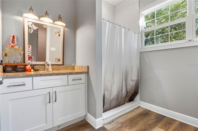 bathroom featuring vanity, hardwood / wood-style floors, and curtained shower