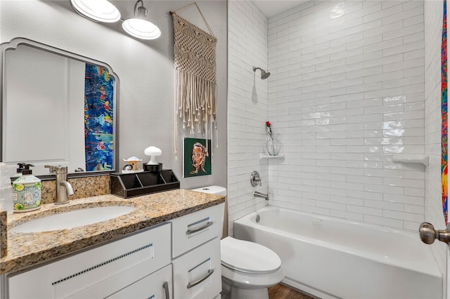 full bathroom with vanity, toilet, and tiled shower / bath