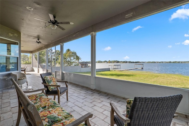 view of patio featuring a water view and ceiling fan