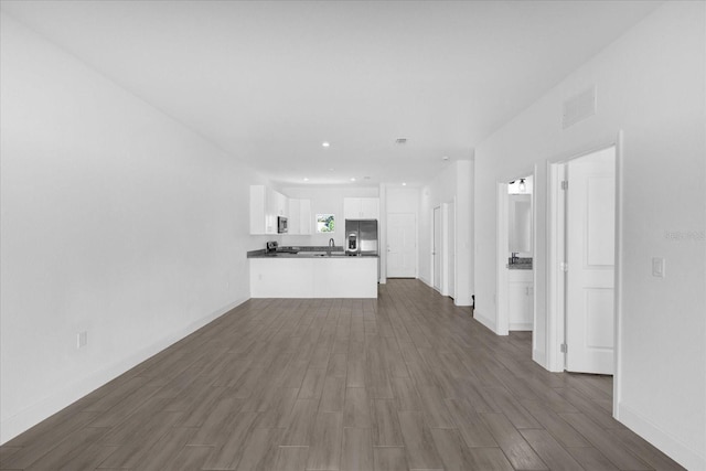 unfurnished living room with dark hardwood / wood-style flooring