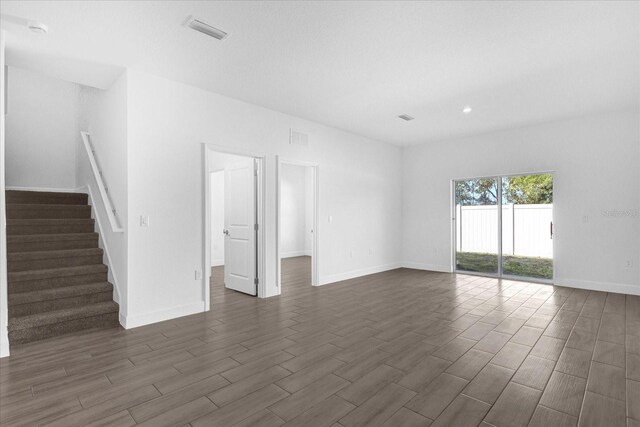 454 Lake Shore Pkwy, Davenport, FL 33896 - spare room with dark wood-type flooring, stairs, baseboards, recessed lighting, and a smoke detector