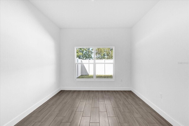 454 Lake Shore Pkwy, Davenport, FL 33896 - empty room with wood tiled floors and baseboards