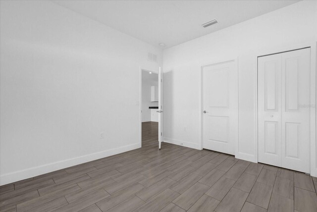 454 Lake Shore Pkwy, Davenport, FL 33896 - unfurnished bedroom with wood finished floors and baseboards