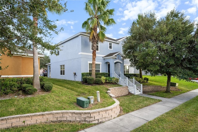 view of front of property featuring stucco siding and a front yard