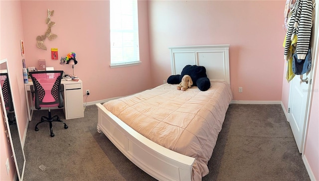 bedroom featuring dark carpet