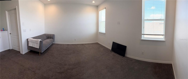 unfurnished room with dark colored carpet