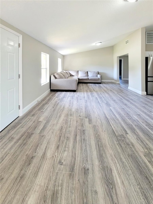 unfurnished living room featuring light wood-type flooring