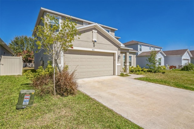 traditional-style home featuring a front yard, concrete driveway, an attached garage, and stucco siding