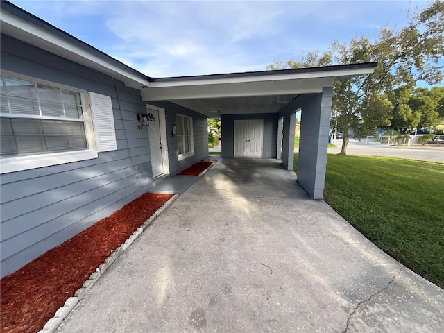 exterior space with a lawn and a carport