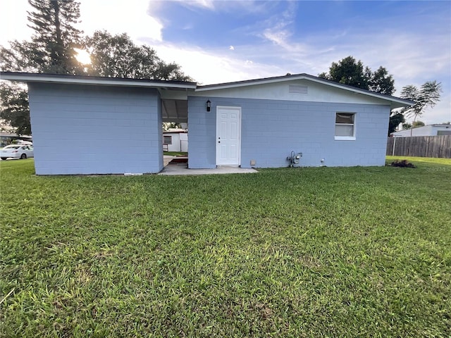 back of property featuring a lawn